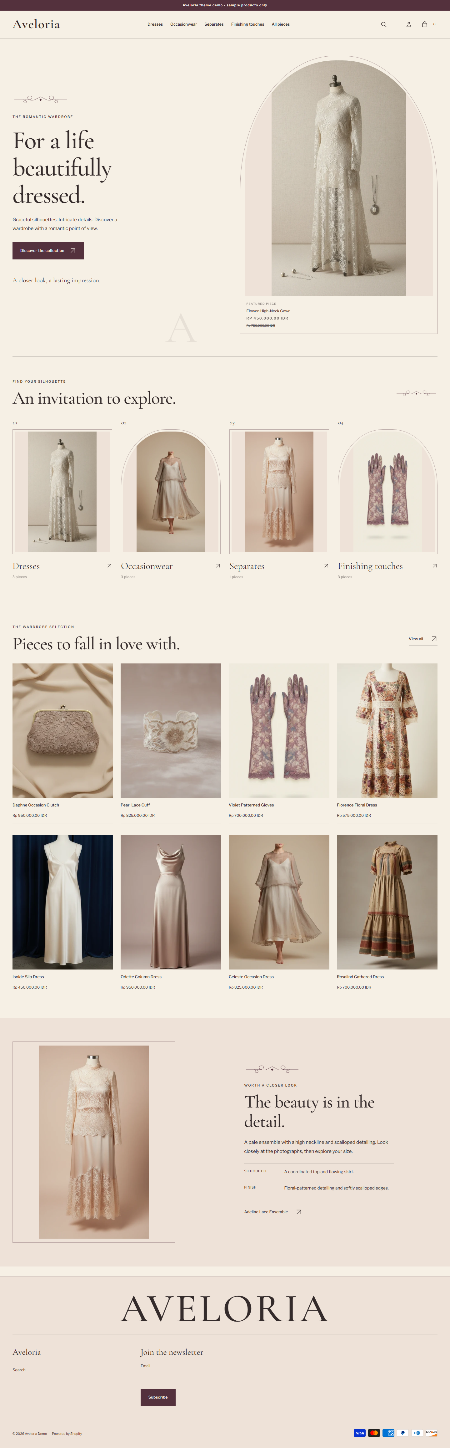 Actual Aveloria desktop homepage with fine-line framing, wardrobe doorways and real garment photography.